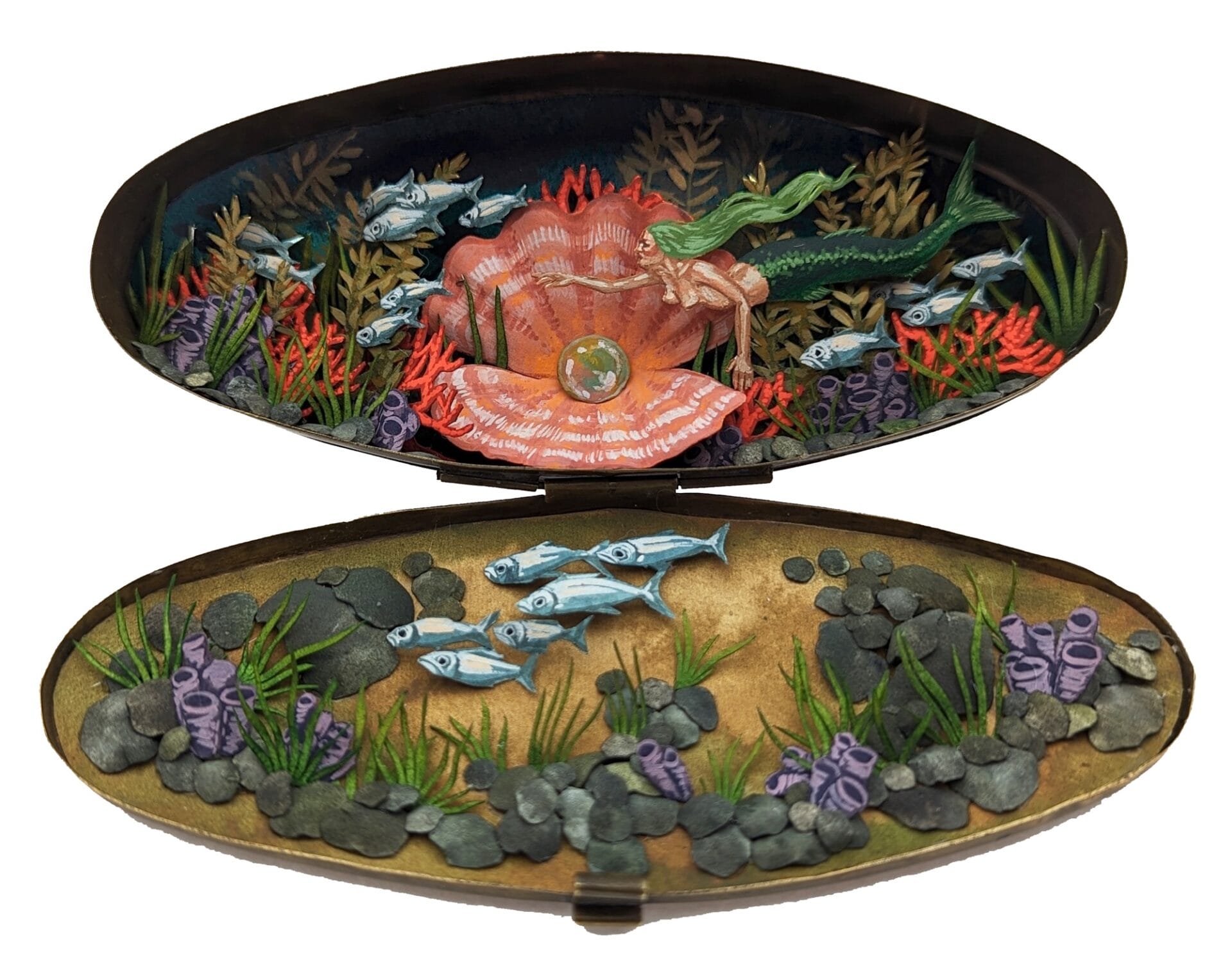 a tiny diorama made from watercolor-painted paper inside of a vintage cosmetics compact depicting a sea scene with a large clam, a school of fish, and coral