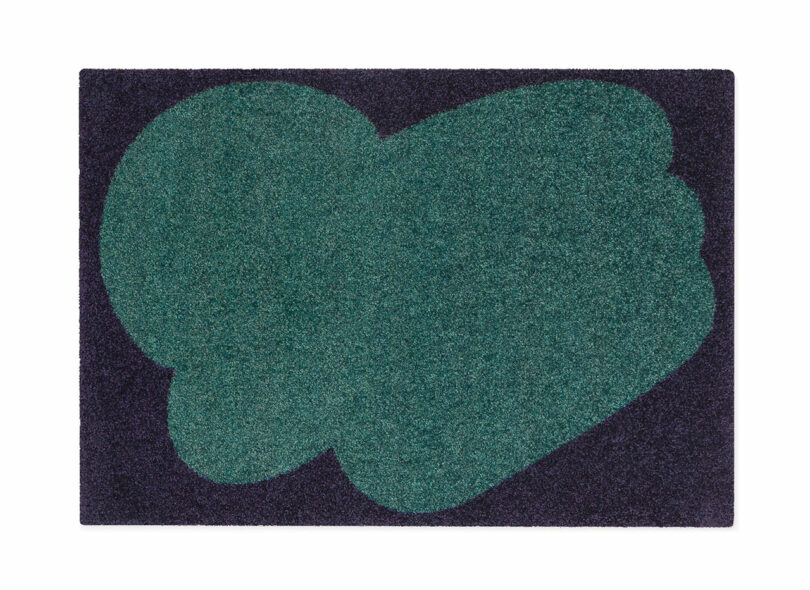 two tone green and black floor mat with abstract pattern