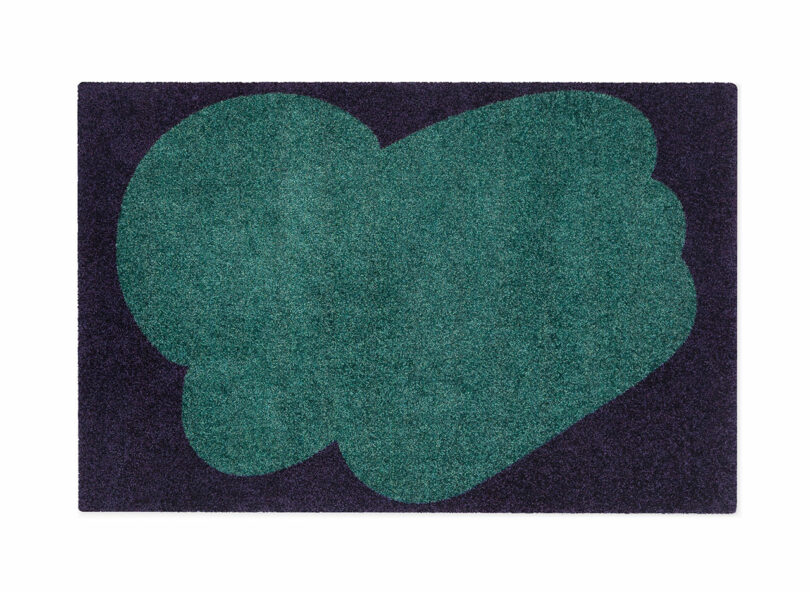 two tone green and black floor mat with abstract pattern