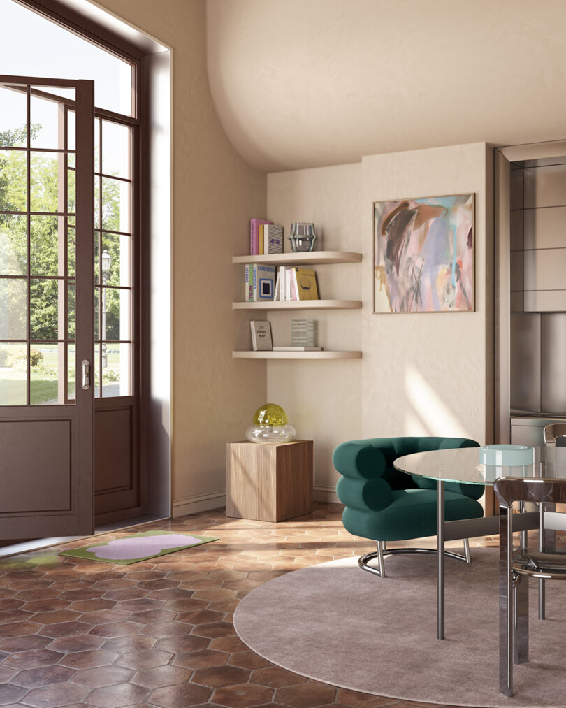 Bright, contemporary living room with terracotta tiles, a round glass table, a green modular sofa, and sunlight streaming through a large door window