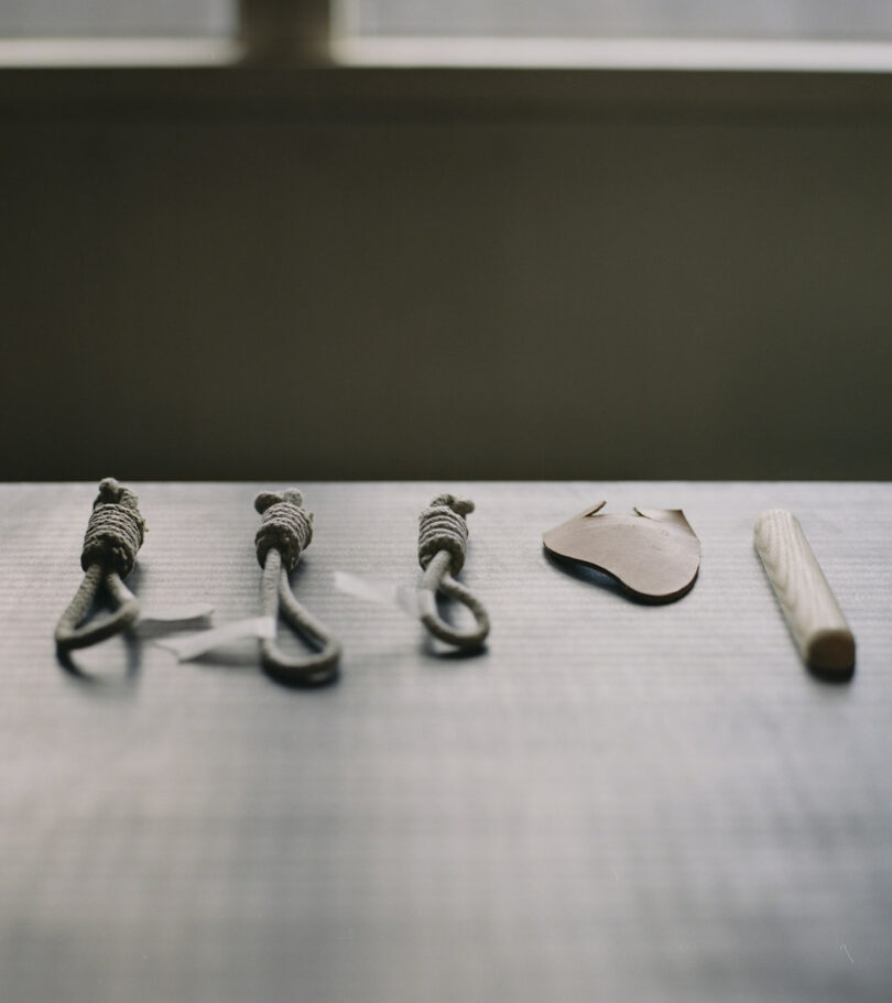 rope, leather, and wood scraps on a table