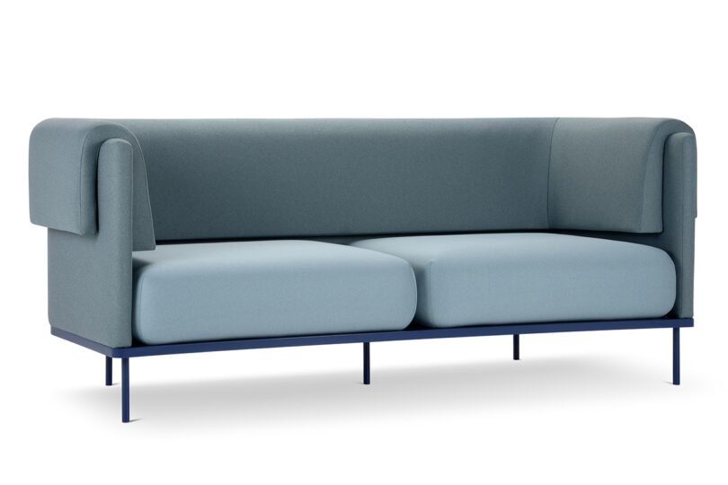A modern blue sofa with a minimalist design, featuring rectangular cushions and a black metal frame, shown against a white background.