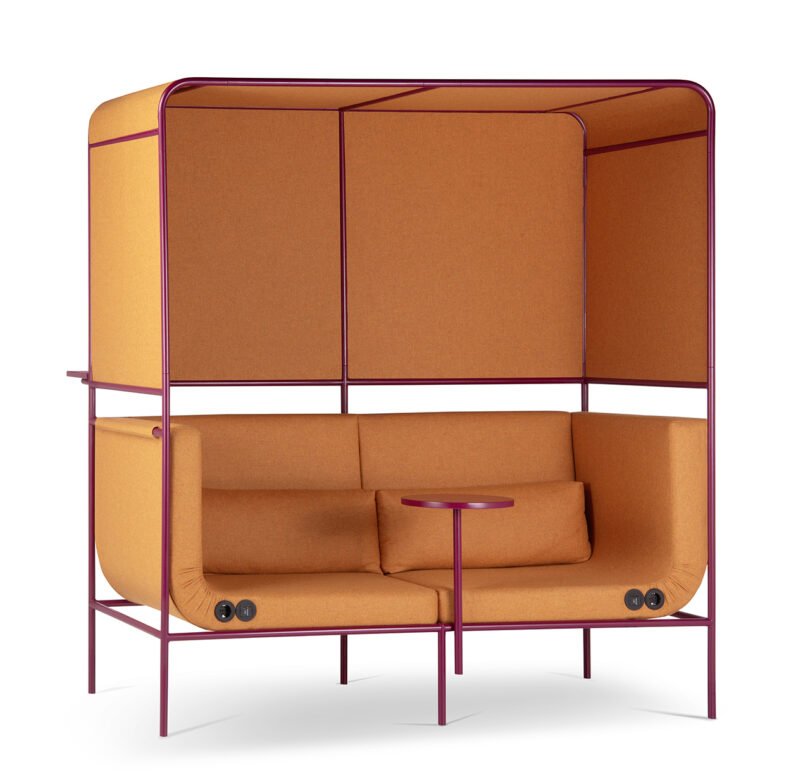 A modern couch with an overhead canopy and built-in side panels, featuring orange upholstery and a small round table attached to the frame.