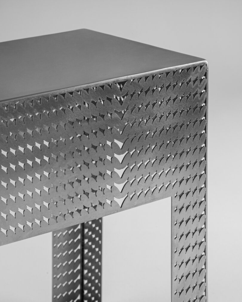 stainless steel metal stool on a grey background