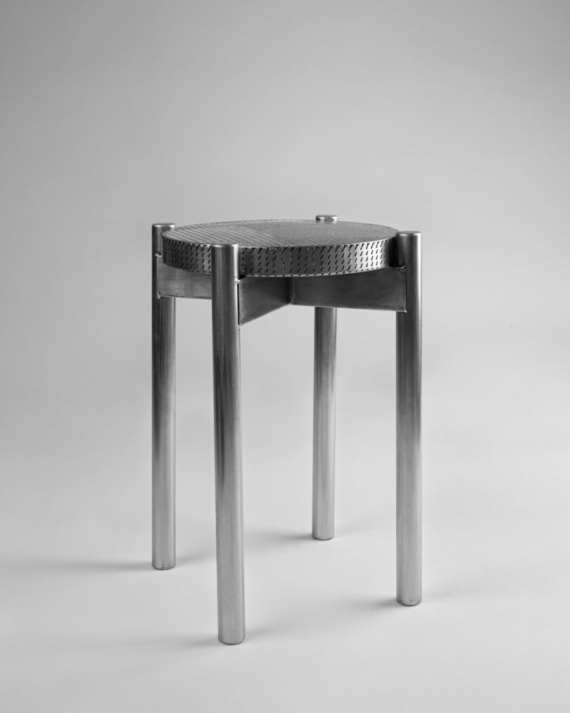 stainless steel metal stool on a grey background