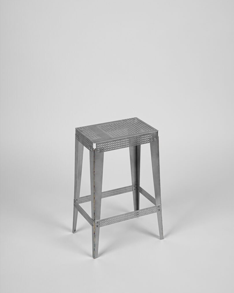 stainless steel metal stool on a grey background
