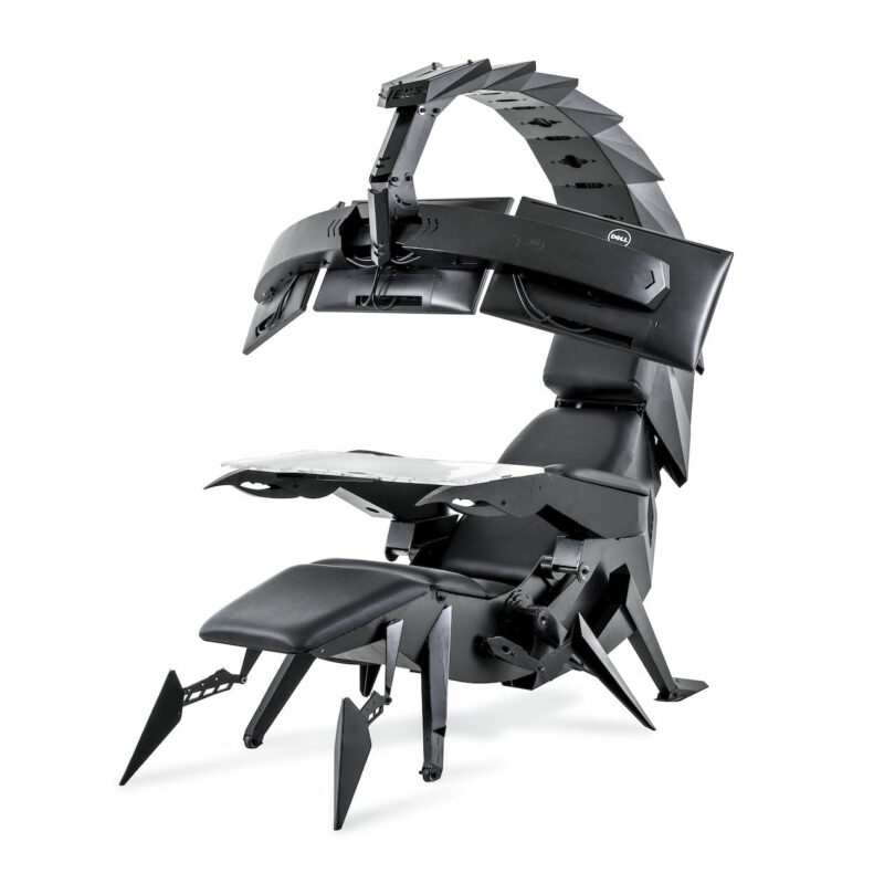 High-tech, black scorpion-inspired workstation with an adjustable ergonomic chair, multiple monitor mounts, and a retractable desk surface