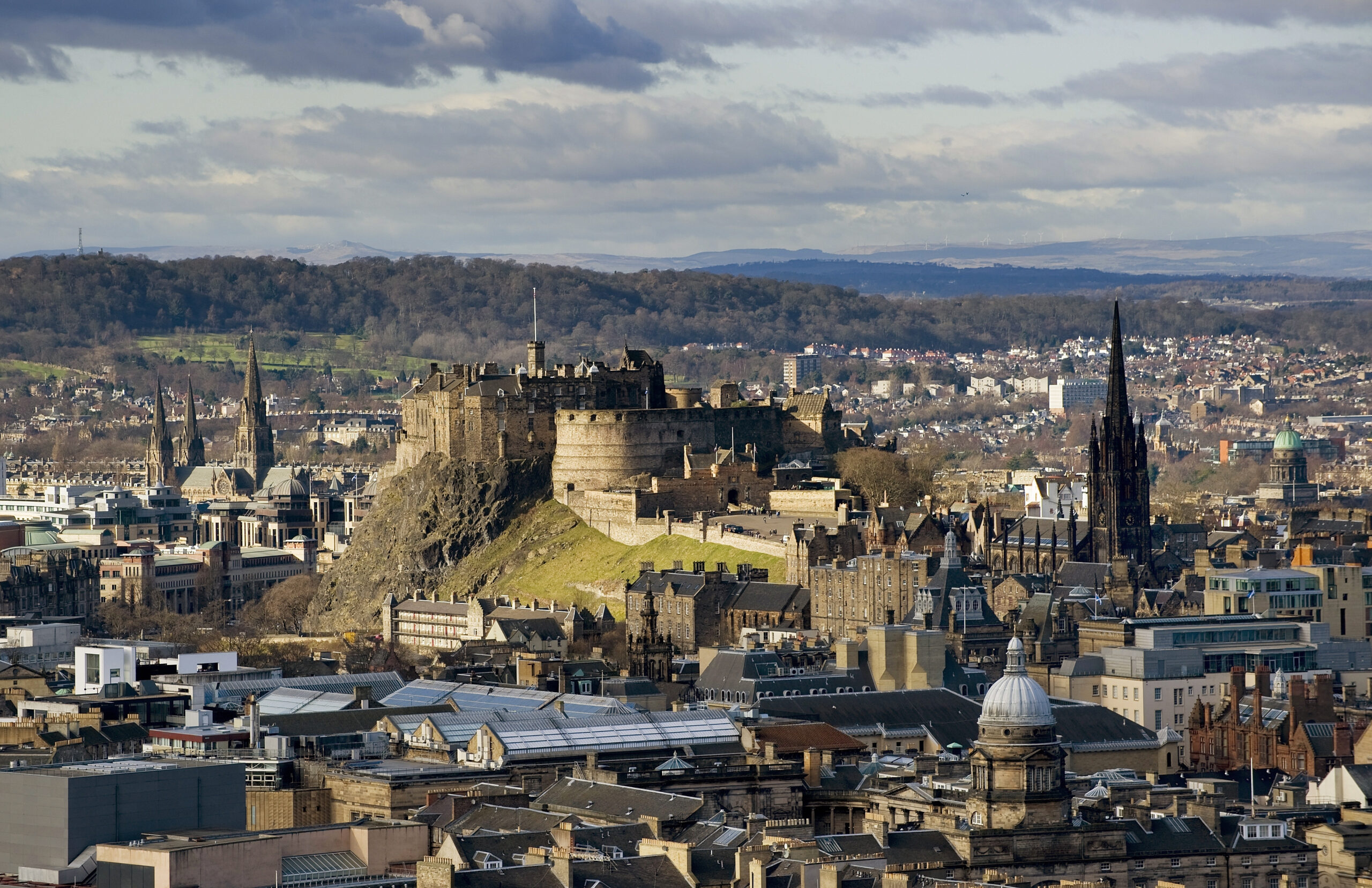 Edinburgh Castle looms handsomely over the center, calling out to be explored. The skyline of central Edinburgh, dominated by Edinburgh Castle.
