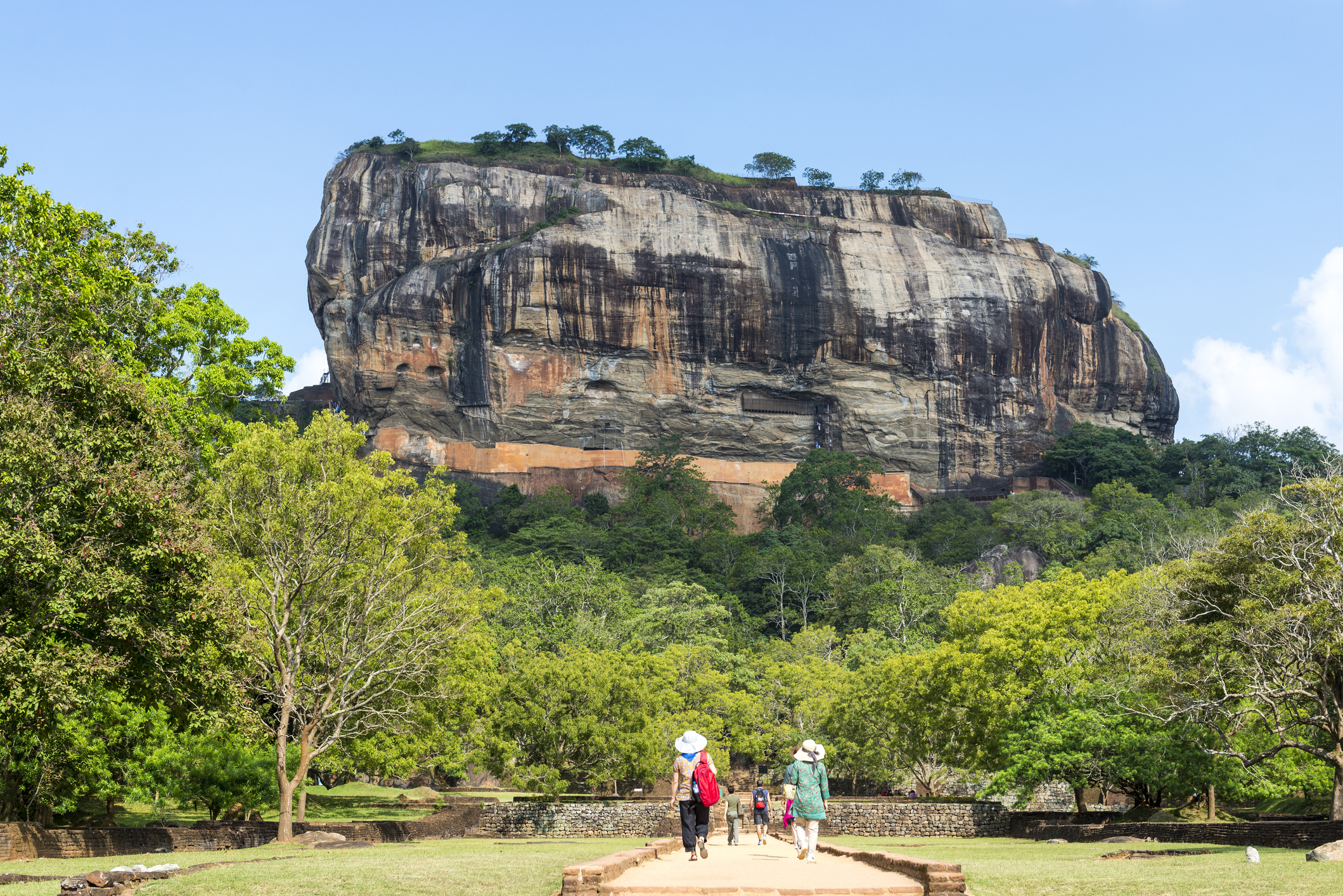 Sigiriya is one of Sri Lanka's most dramatic ancient sites. Visitors walk through gardens to the rocky ruins of Sigiriya, Sri Lanka.