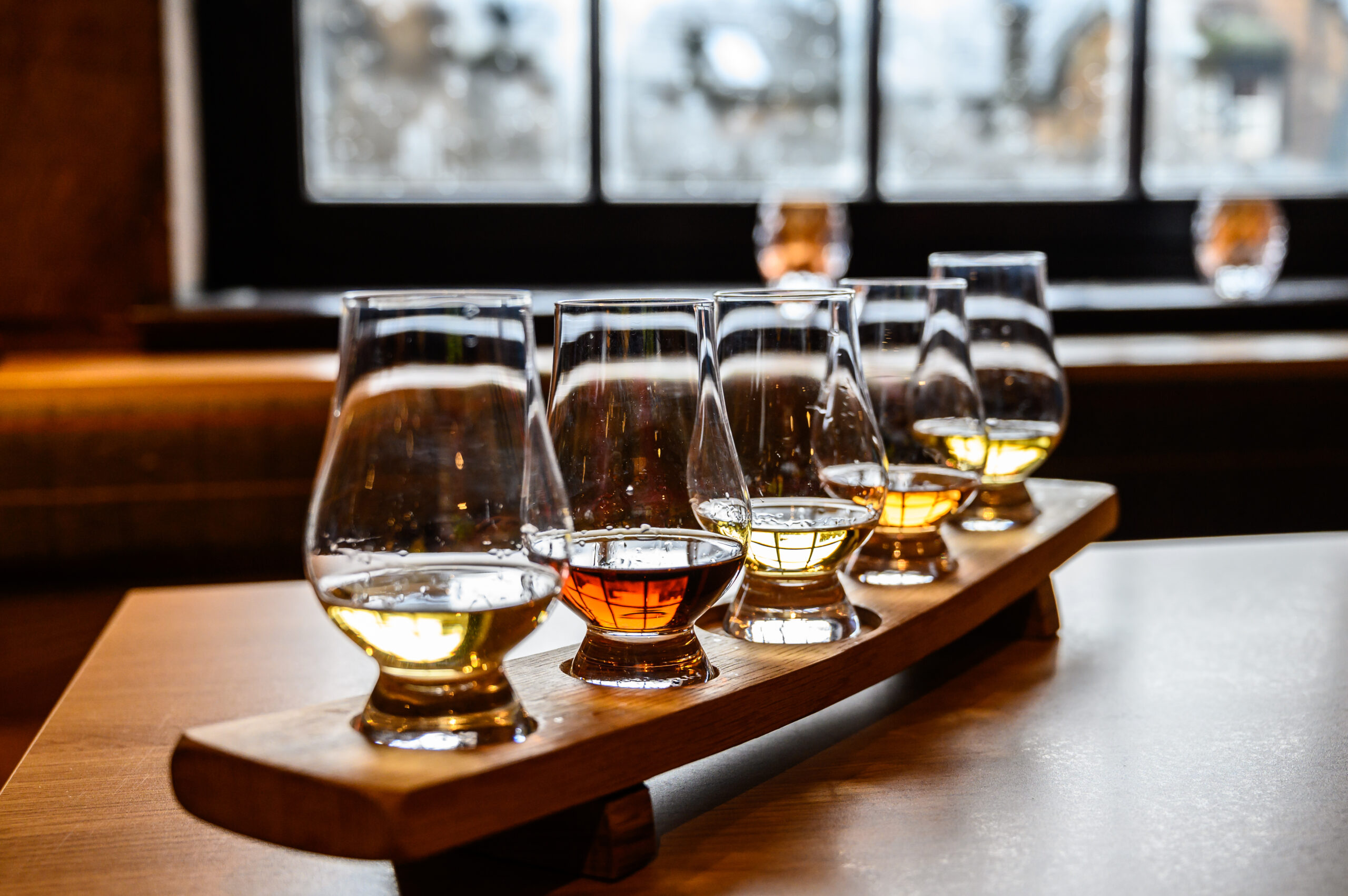 Glasses of Scotch whisky ready to sample at a distillery tour in Scotland. Glasses of Scotch whisky ready to sample at a distillery tour in Scotland.